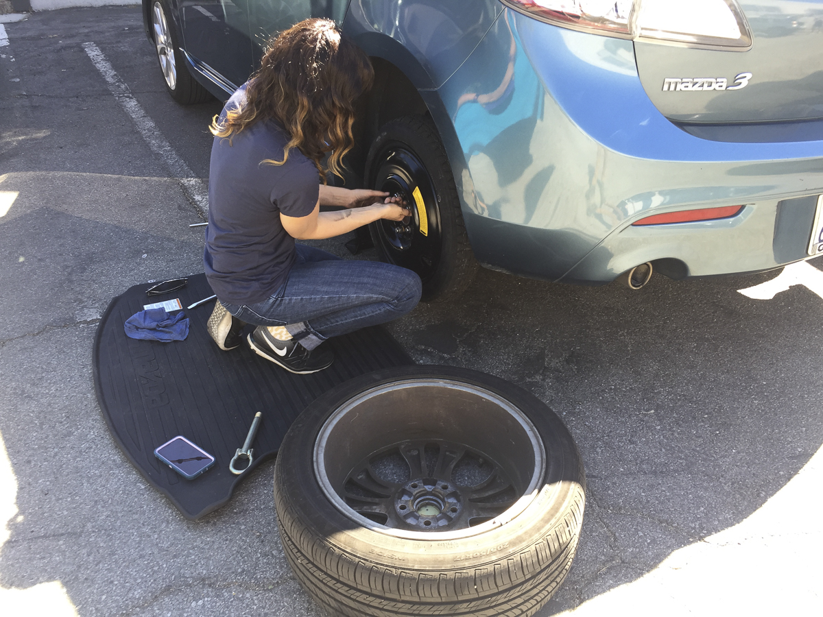 photo of someone changing a tire